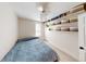 Cozy bedroom with blue bedding and built-in shelving for storage and display at 422 Atwood St, Longmont, CO 80501