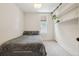 This cozy bedroom features gray carpet, a twin bed, and handy built in shelving at 422 Atwood St, Longmont, CO 80501