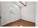 Bright bedroom with a window, wood-look flooring, and neutral walls at 422 Atwood St, Longmont, CO 80501