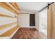 The versatile bonus room with wood floor and sliding barn door provides flexible living space at 422 Atwood St, Longmont, CO 80501