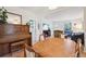Spacious dining room with hardwood floors, vintage piano, and seamless flow to living room at 422 Atwood St, Longmont, CO 80501