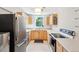 An efficiently designed kitchen features stainless steel appliances and light wood cabinets for ample storage at 422 Atwood St, Longmont, CO 80501