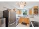 Efficient kitchen with stainless steel appliances, light wood cabinets, and a view from the window at 422 Atwood St, Longmont, CO 80501