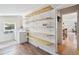 A well-lit laundry room with open shelving, a window, a washer, and a dryer at 422 Atwood St, Longmont, CO 80501
