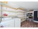 Functional laundry room with open shelving, washer and dryer, perfect for storage and convenience at 422 Atwood St, Longmont, CO 80501