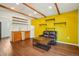 Living room featuring hardwood floors, vaulted ceilings with wood beams, and a kitchenette at 422 Atwood St, Longmont, CO 80501
