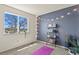 Bright bedroom with a large window, string lights, and book shelving creating a cozy atmosphere at 265 N Holcomb St, Castle Rock, CO 80104