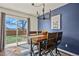 Elegant dining room with modern chandelier and a sliding glass door that offers a view of the backyard at 265 N Holcomb St, Castle Rock, CO 80104