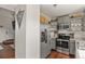 Modern kitchen with stainless steel appliances, updated grey cabinets, and a view into the living area at 265 N Holcomb St, Castle Rock, CO 80104