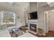 Cozy living area with a fireplace, mounted TV, and ample natural light from a large window at 265 N Holcomb St, Castle Rock, CO 80104
