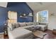 Bright and airy living room featuring hardwood floors, large windows, and a plush sectional sofa at 265 N Holcomb St, Castle Rock, CO 80104