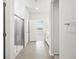 An elegant bathroom features a tiled shower, a white vanity, and access to a bright, inviting space at 9069 Pitkin St, Commerce City, CO 80022