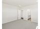 A light, airy bedroom features neutral walls, gray carpet, and bathroom access at 9069 Pitkin St, Commerce City, CO 80022