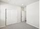 Bedroom featuring neutral carpet, closet with sliding doors, and bright interior at 9069 Pitkin St, Commerce City, CO 80022