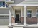 Covered entrance with brick accents leading to the front door and attached two-car garage at 9069 Pitkin St, Commerce City, CO 80022