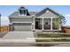 Charming single-Gathering home with a two-car garage, inviting front porch and manicured lawn at 9069 Pitkin St, Commerce City, CO 80022