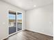 Bright living room with sliding glass door to a deck and scenic outdoor views at 9069 Pitkin St, Commerce City, CO 80022