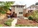Cozy backyard with a patio, garden beds, string lights, and a wooden fence for privacy at 1267 Clayton St, Denver, CO 80206