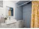 Modern bathroom with a sleek sink, colorful shower, and minimalist design elements at 1267 Clayton St, Denver, CO 80206