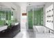 Bright bathroom with double sinks, a separate shower, and a luxurious soaking tub at 1267 Clayton St, Denver, CO 80206