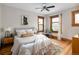 Charming bedroom with wood floors, leaded windows, and a cozy sitting area at 1267 Clayton St, Denver, CO 80206