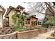Charming two-story brick home featuring a lovely front garden and classic architectural details at 1267 Clayton St, Denver, CO 80206