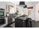 Modern kitchen with stainless steel appliances, center island, and sleek black countertops at 1267 Clayton St, Denver, CO 80206