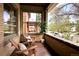 Relaxing covered porch with brick accents, wooden chairs, and a view of the neighborhood at 1267 Clayton St, Denver, CO 80206