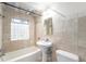 Stylish bathroom with travertine tiles and decorative accent at 665 Washington St # 5B, Denver, CO 80203