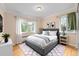 Comfortable bedroom featuring hardwood floors and ample natural light at 665 Washington St # 5B, Denver, CO 80203