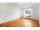 Bright bedroom featuring hardwood floors and a large window at 665 Washington St # 5B, Denver, CO 80203