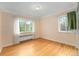 Sunny bedroom with hardwood floors and natural light from large windows at 665 Washington St # 5B, Denver, CO 80203