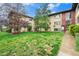 Traditional apartment building featuring a well-maintained lawn, mature trees, and charming curb appeal at 665 Washington St # 5B, Denver, CO 80203