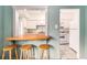 Charming kitchen pass-through with bar seating and modern white appliances at 665 Washington St # 5B, Denver, CO 80203