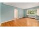 Inviting living area with wood floors, a large window, and serene blue walls at 665 Washington St # 5B, Denver, CO 80203