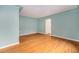 Serene and spacious living room with hardwood flooring and fresh blue paint at 665 Washington St # 5B, Denver, CO 80203