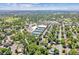 Community aerial view showcasing tennis courts, homes, and lush greenery at 6330 E Vassar Ave, Denver, CO 80222