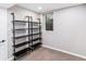 Finished basement with shelving, a carpeted floor and a small egress window at 6330 E Vassar Ave, Denver, CO 80222