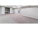 Spacious finished basement with carpet, storage closet and access to other spaces at 6330 E Vassar Ave, Denver, CO 80222