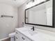Bright bathroom with white vanity, quartz countertops, modern fixtures, and subway tile in the shower at 6330 E Vassar Ave, Denver, CO 80222