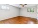 Bedroom with hardwood floors, fan, and natural light from two windows at 6330 E Vassar Ave, Denver, CO 80222