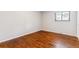 Bedroom with hardwood floors and natural light from a window at 6330 E Vassar Ave, Denver, CO 80222