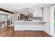 Beautiful kitchen with stainless appliances, an island, and a seamless open design to the dining area at 6330 E Vassar Ave, Denver, CO 80222