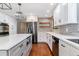 Well-designed kitchen featuring stainless steel appliances, custom cabinets, and granite countertops at 6330 E Vassar Ave, Denver, CO 80222