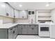 Updated laundry room with gray cabinets, white countertops, and stainless steel faucet at 6330 E Vassar Ave, Denver, CO 80222