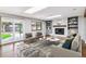 Bright living room with a cozy fireplace, skylights, and stylish furniture at 6330 E Vassar Ave, Denver, CO 80222