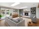 Inviting living room featuring built-in bookshelves, a fireplace, and lots of natural light at 6330 E Vassar Ave, Denver, CO 80222