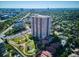 Stunning aerial view of high-rise condo building surrounded by lush greenery and park at 3131 E Alameda Ave # 1107, Denver, CO 80209