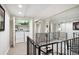 Second floor hallway with staircase, laundry closet and mirrored wall to reflect the natural light at 3131 E Alameda Ave # 1107, Denver, CO 80209