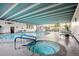 Bright indoor pool area featuring a hot tub, ample seating, and large windows at 3131 E Alameda Ave # 1107, Denver, CO 80209